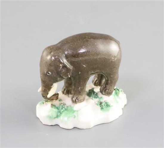 A Rockingham porcelain figure of an elephant, c.1830, L. 4.7cm, restorations